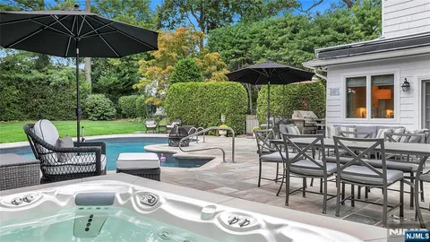 a view of patio with chairs and table under an umbrella