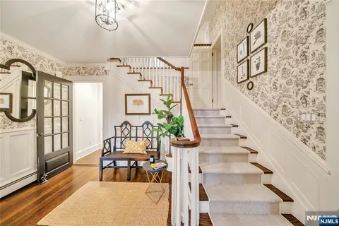 a view of staircase with furniture and a fireplace