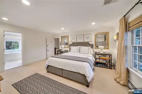 a bedroom with a large bed and a large window