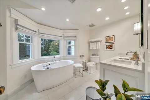 a spacious bathroom with a bathtub and a sink