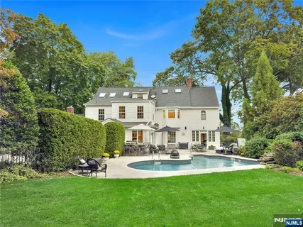a view of a house with backyard and sitting area