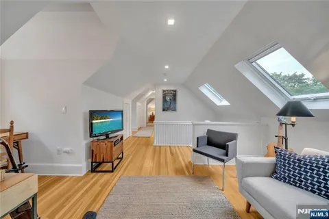 a bed room with furniture and a flat screen tv