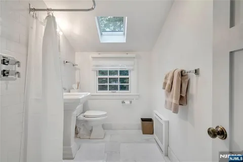 a bathroom with a toilet sink and shower