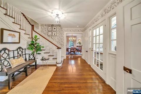 a view of a hallway with wooden floor and windows
