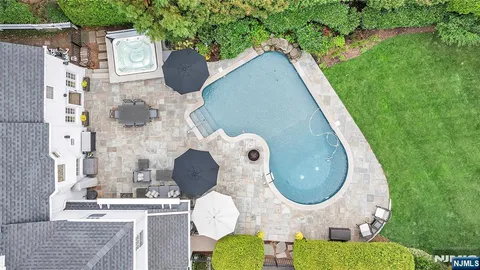 a aerial view of a house with outdoor space and swimming pool