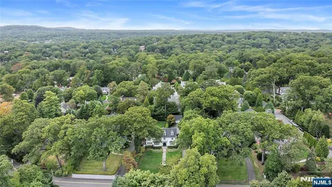 an aerial view of residential houses with outdoor and green space