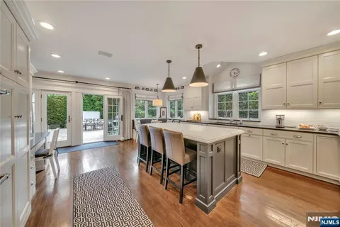 a kitchen with stainless steel appliances granite countertop a stove and a wooden floors