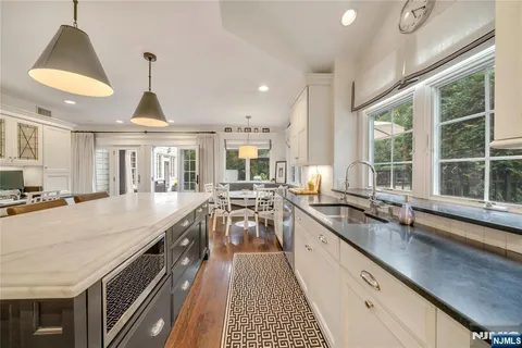 a large kitchen with granite countertop a large window