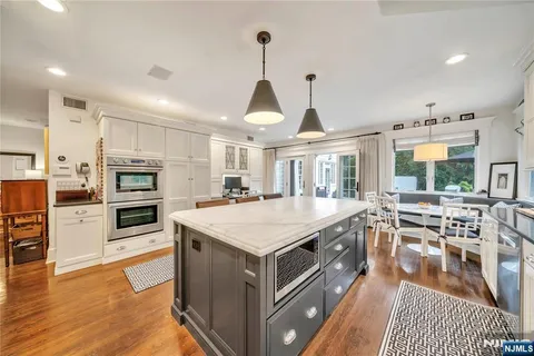 a large kitchen with stainless steel appliances granite countertop a stove oven and a refrigerator