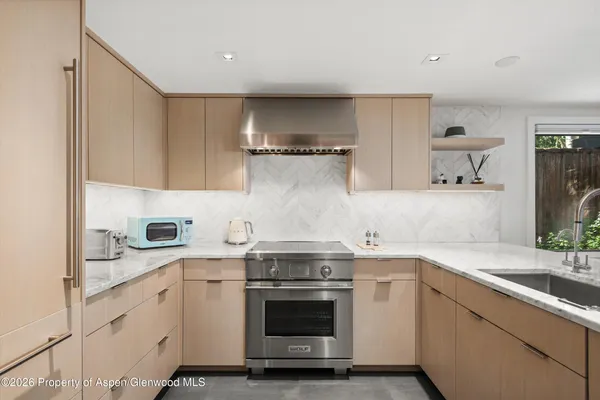 a kitchen with a stove and a sink