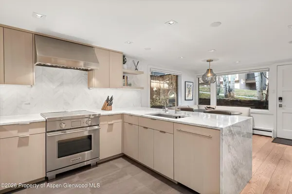 a kitchen with a stove top oven sink and cabinets