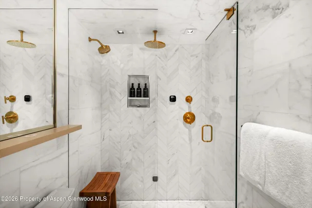 a bedroom with two beds and a flat screen tv