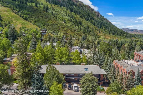 an aerial view of a house with a yard