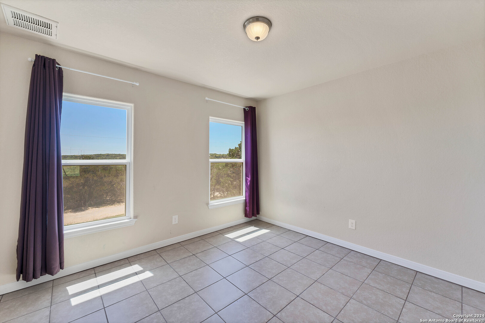 2407 Golf Drive Spring Branch, TX 78070 - Photo 17 of 29 an empty room with windows