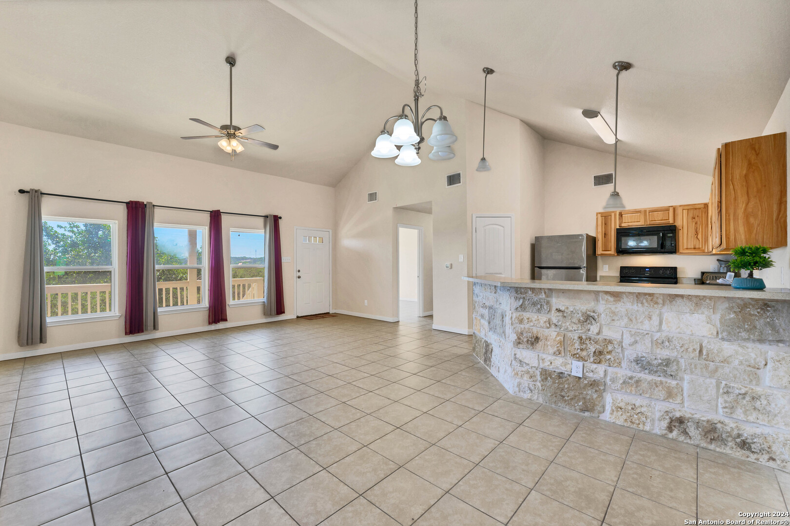 2407 Golf Drive Spring Branch, TX 78070 - Photo 2 of 29 a view of a kitchen with kitchen island granite countertop a stove a sink and a chandelier