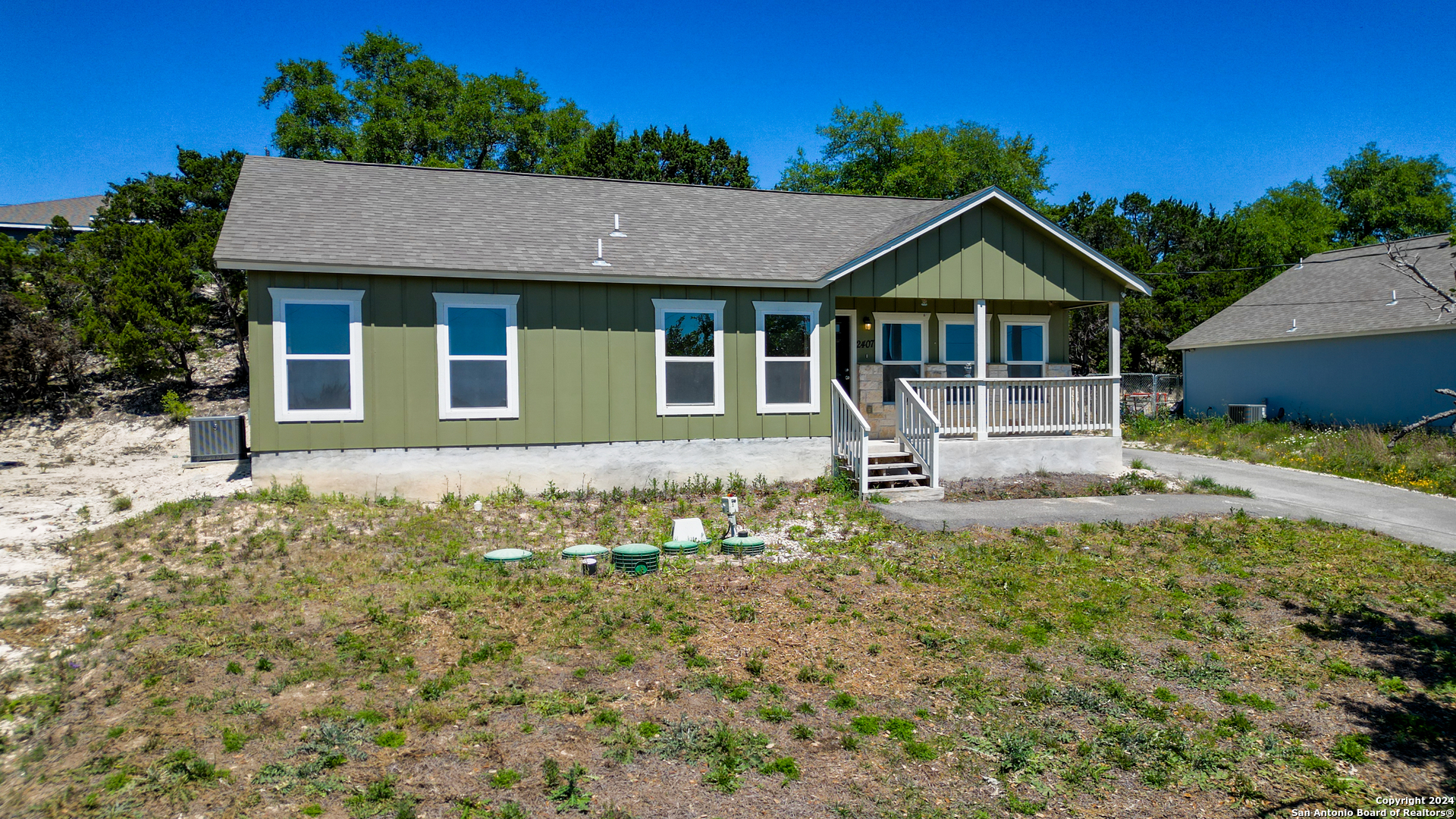 2407 Golf Drive Spring Branch, TX 78070 - Photo 3 of 29 a front view of a house with a yard