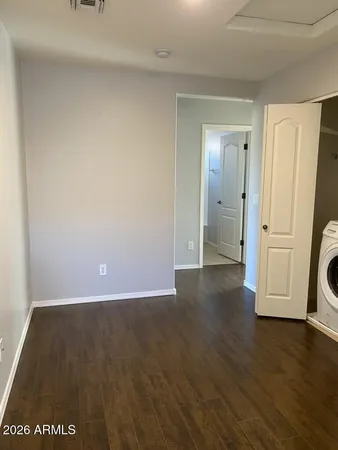 a view of a room with wooden floor and bathroom