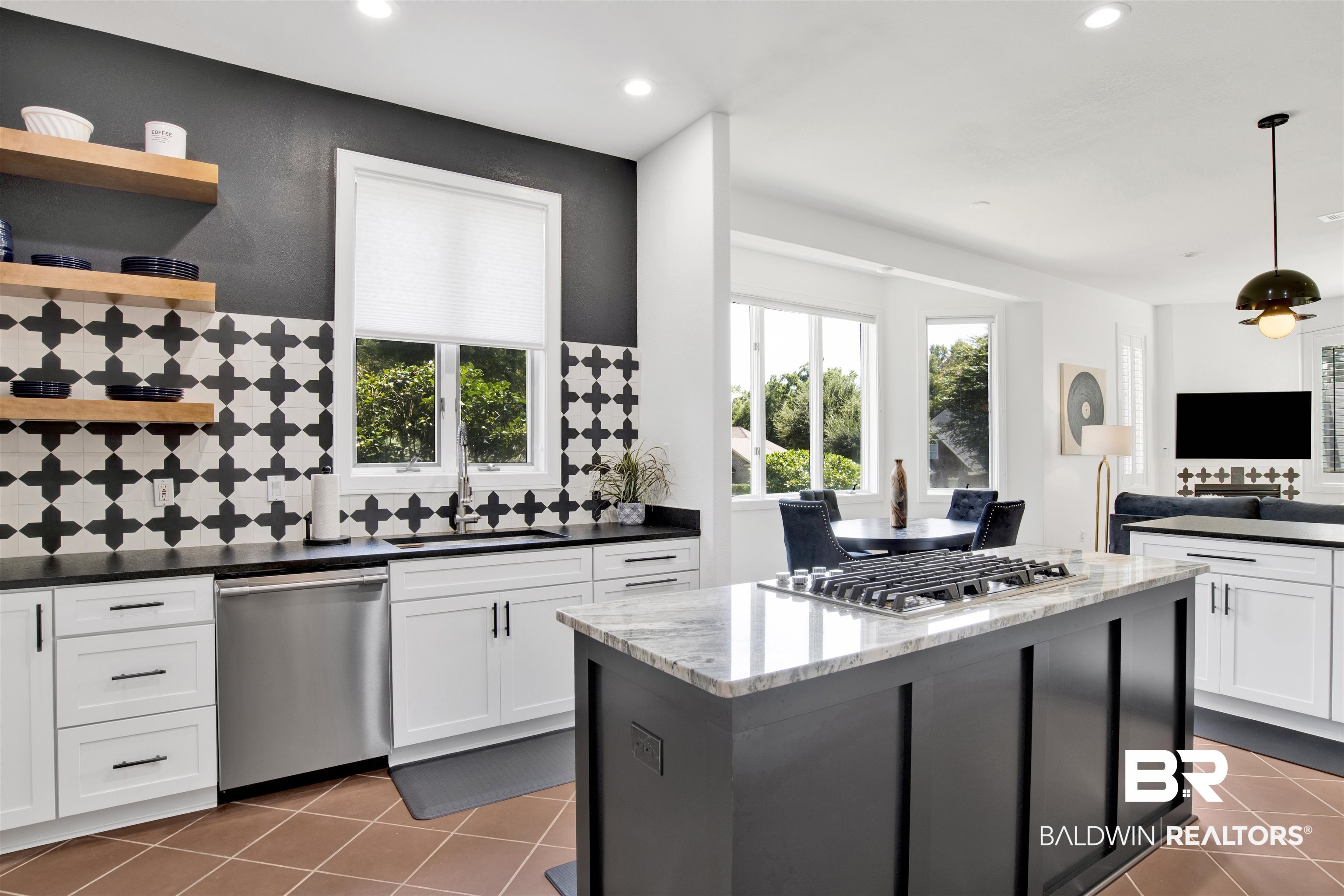115 McIntosh Bluff Road Fairhope, AL 36532 - Photo 9 of 46 Kitchen with dark tile patterned floors, a center island, stainless steel appliances, decorative light fixtures, and sink