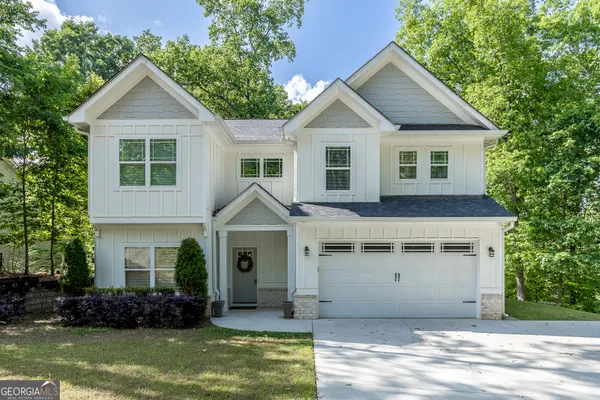 a front view of a house with a yard and garage