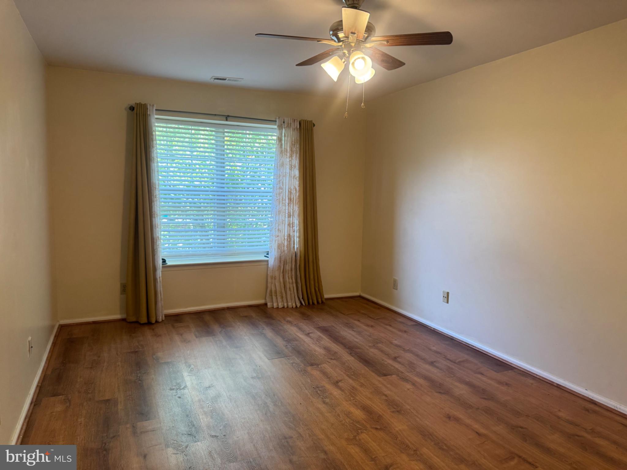 1908 B Ralston Drive Mount Laurel, NJ 08054 - Photo 16 of 21 an empty room with wooden floor fan and windows
