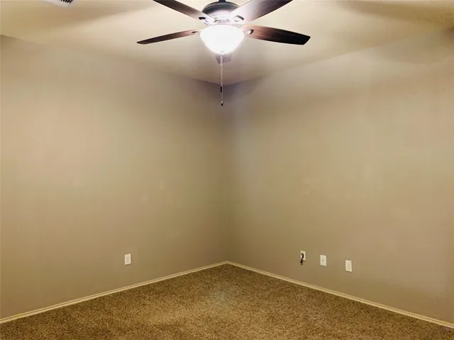 en empty room with a fan and fan