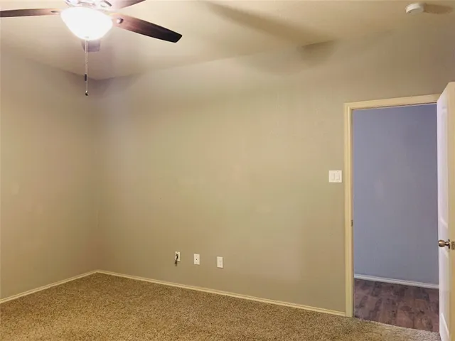 a view of a room with a ceiling fan