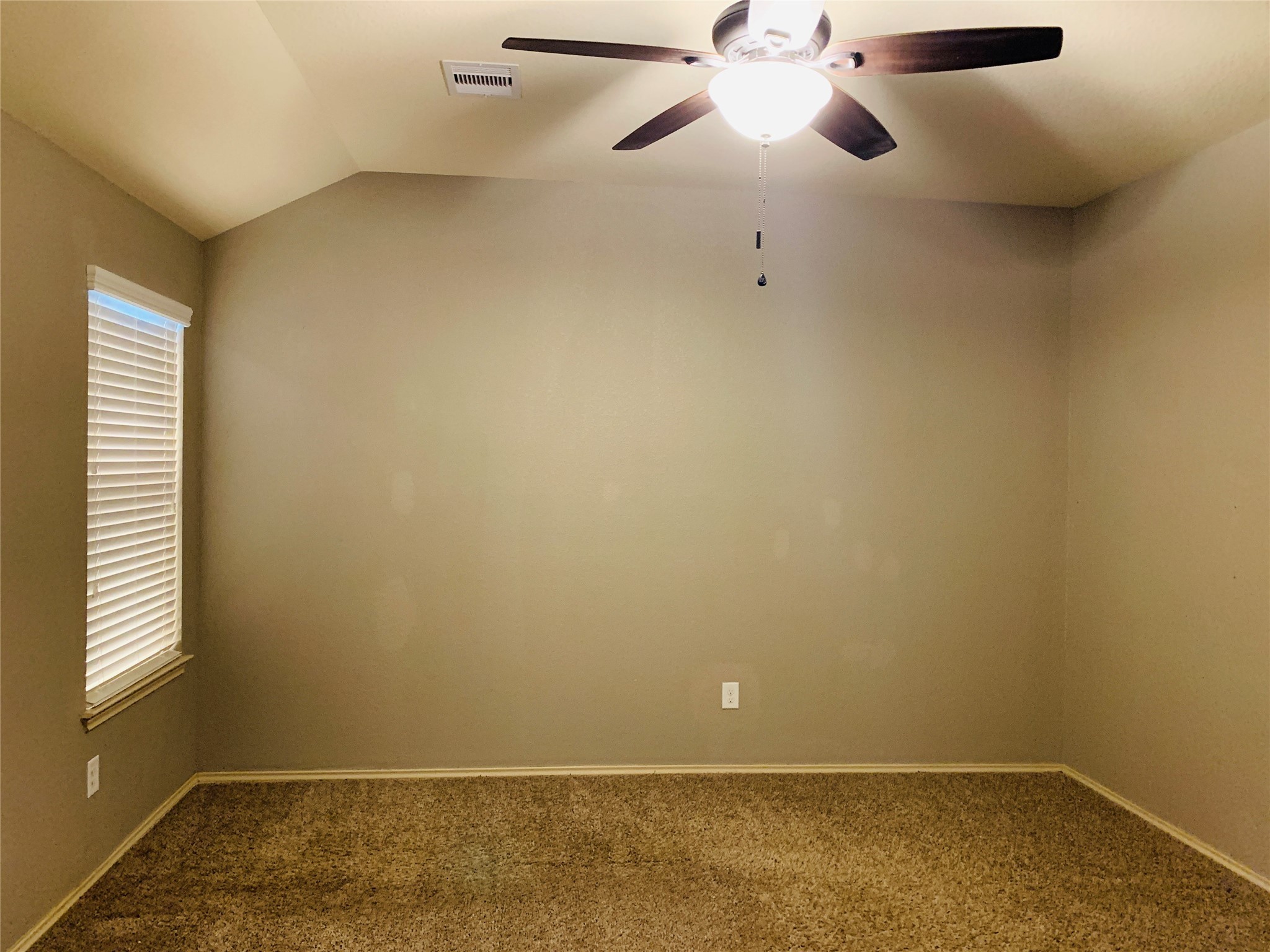 15438 Rancho Joya Way Houston, TX 77049 - Photo 22 of 31 an empty room with a window and a fan