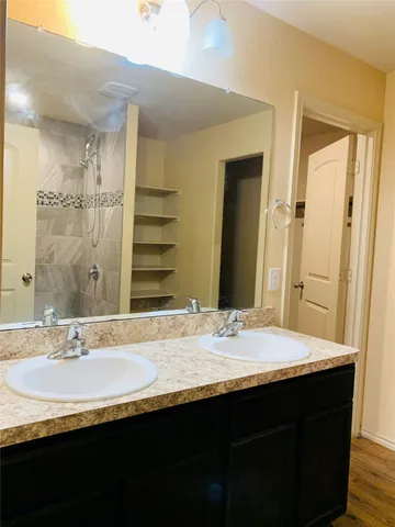 a bathroom with a granite countertop sink and a mirror