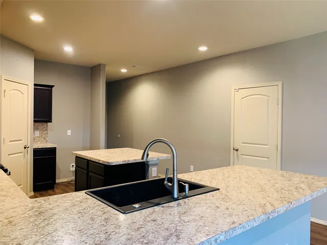 a kitchen with a refrigerator and a sink