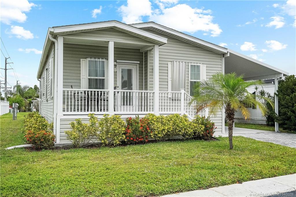 4800 Southeast Federal Highway, Unit 34 Stuart, FL 34997 - Photo 1 of 47 a front view of a house with a garden