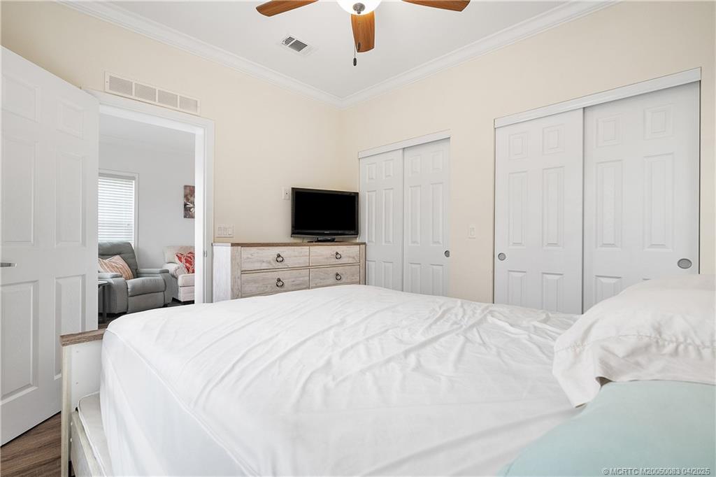 4800 Southeast Federal Highway, Unit 34 Stuart, FL 34997 - Photo 13 of 47 a bedroom with a bed and a flat screen tv