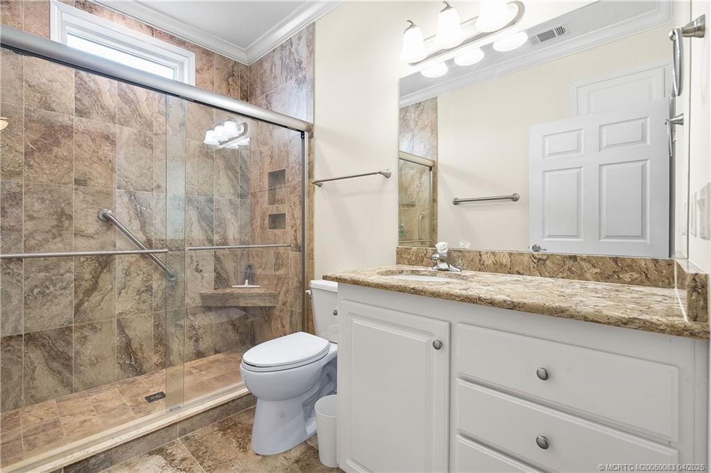 4800 Southeast Federal Highway, Unit 34 Stuart, FL 34997 - Photo 15 of 47 a bathroom with a granite countertop sink a toilet and shower
