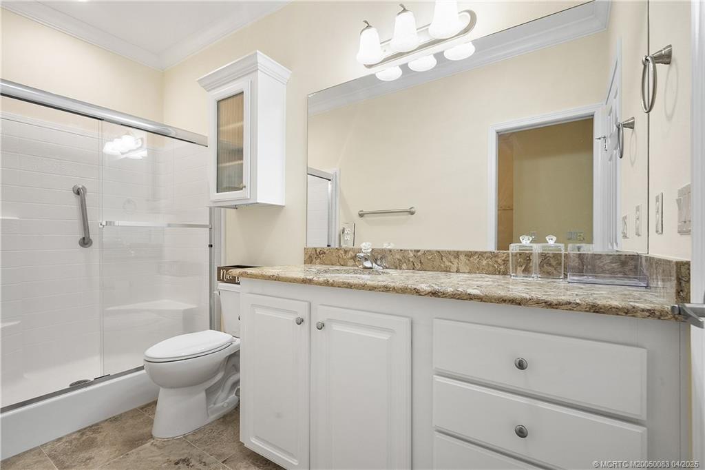4800 Southeast Federal Highway, Unit 34 Stuart, FL 34997 - Photo 18 of 47 a bathroom with a granite countertop sink a toilet and a mirror