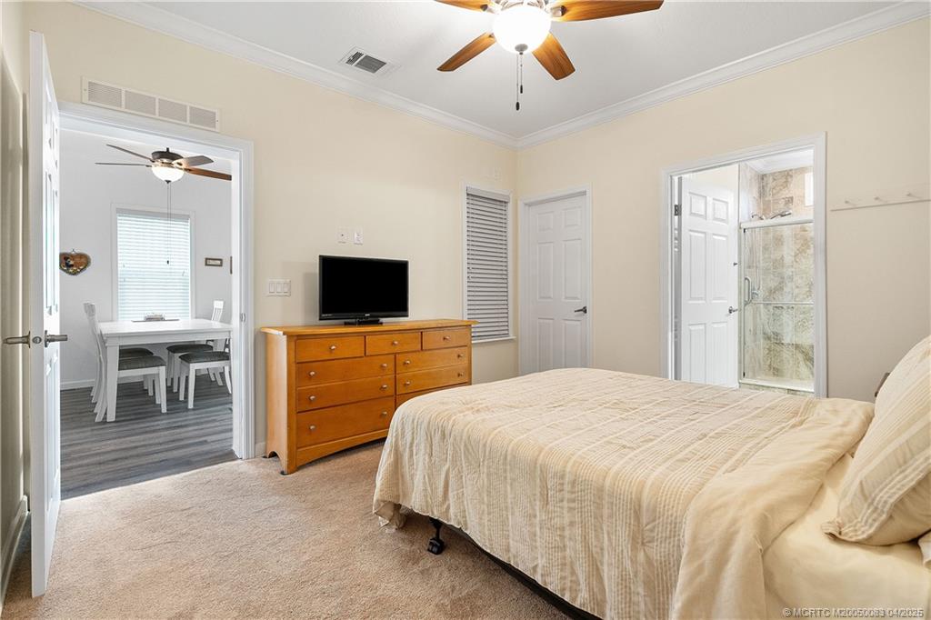 4800 Southeast Federal Highway, Unit 34 Stuart, FL 34997 - Photo 20 of 47 a bedroom with a bed and a flat screen tv