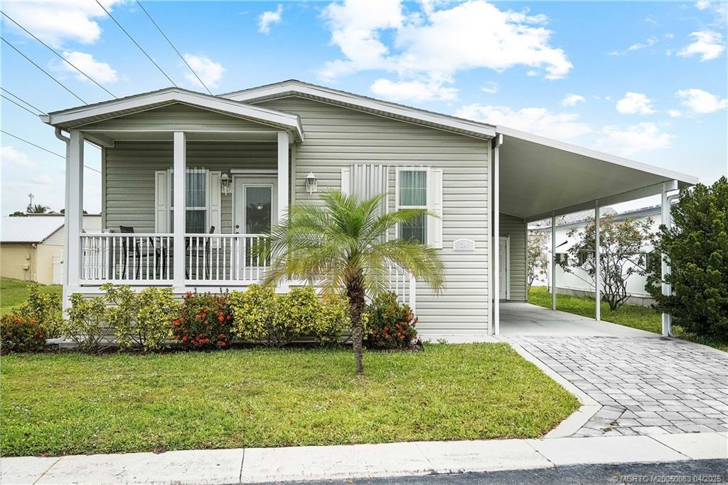 4800 Southeast Federal Highway, Unit 34 Stuart, FL 34997 - Photo 2 of 47 a front view of a house with garden