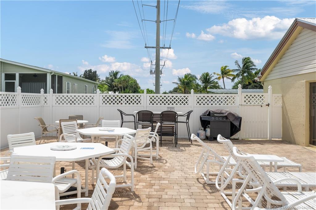 4800 Southeast Federal Highway, Unit 34 Stuart, FL 34997 - Photo 38 of 47 a view of a patio with table and chairs