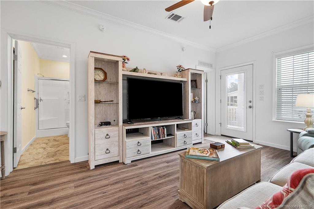 4800 Southeast Federal Highway, Unit 34 Stuart, FL 34997 - Photo 4 of 47 a living room with furniture and a flat screen tv