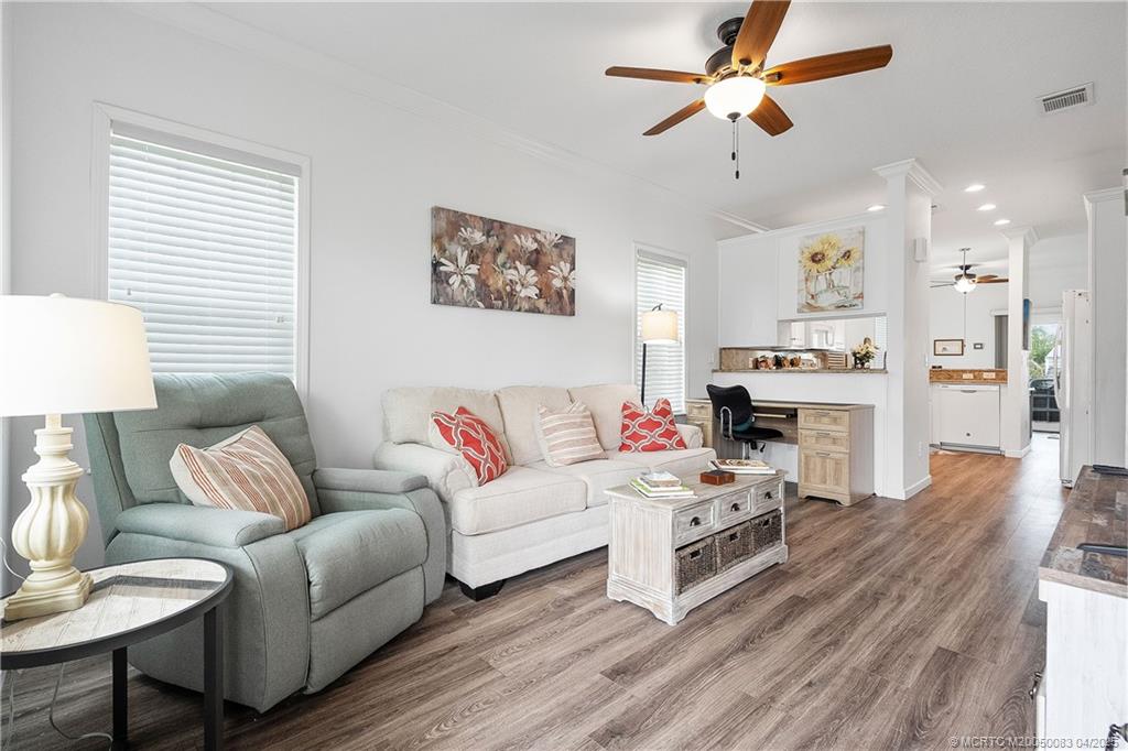 4800 Southeast Federal Highway, Unit 34 Stuart, FL 34997 - Photo 5 of 47 a living room with furniture and a fireplace