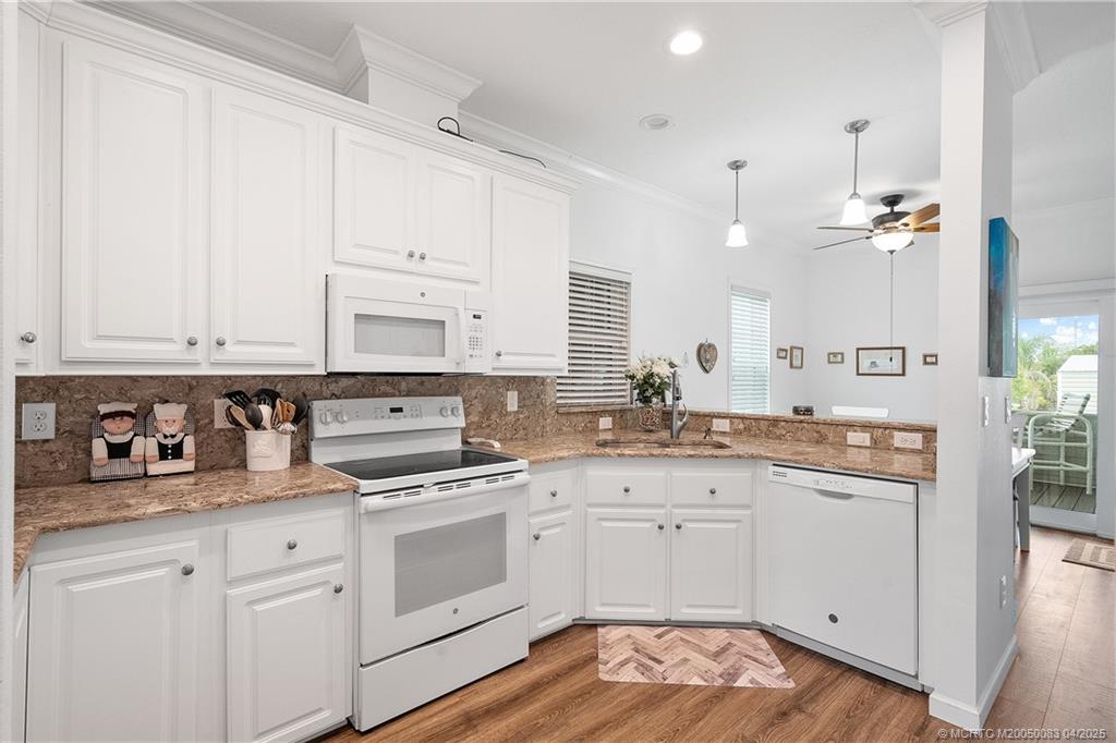 4800 Southeast Federal Highway, Unit 34 Stuart, FL 34997 - Photo 7 of 47 a kitchen with white cabinets and white appliances