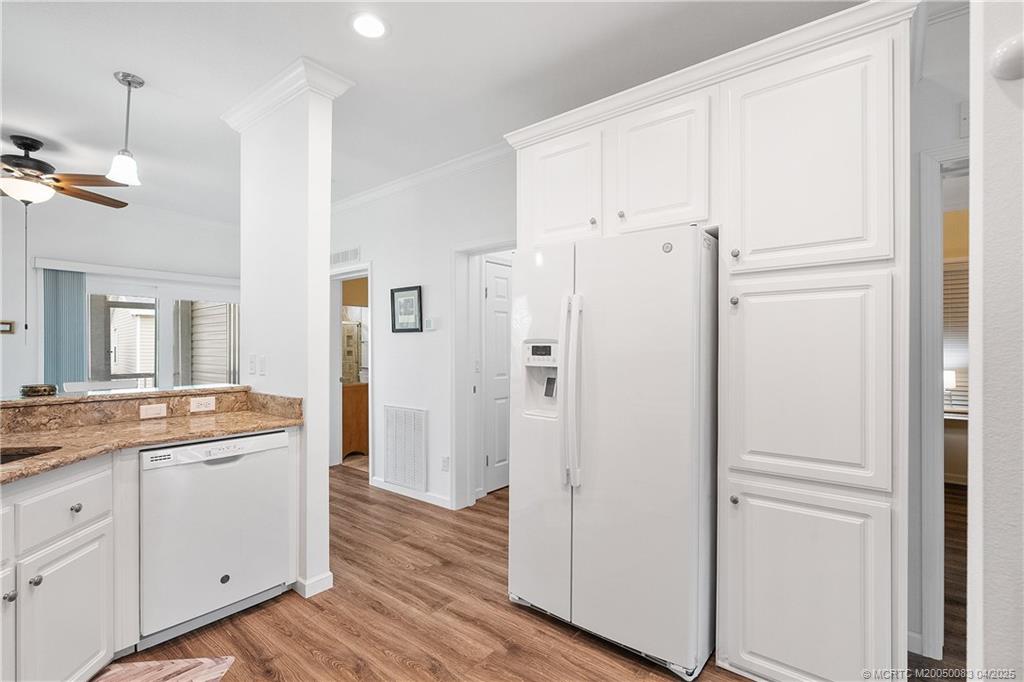 4800 Southeast Federal Highway, Unit 34 Stuart, FL 34997 - Photo 9 of 47 a view of a kitchen with cabinets and wooden floor