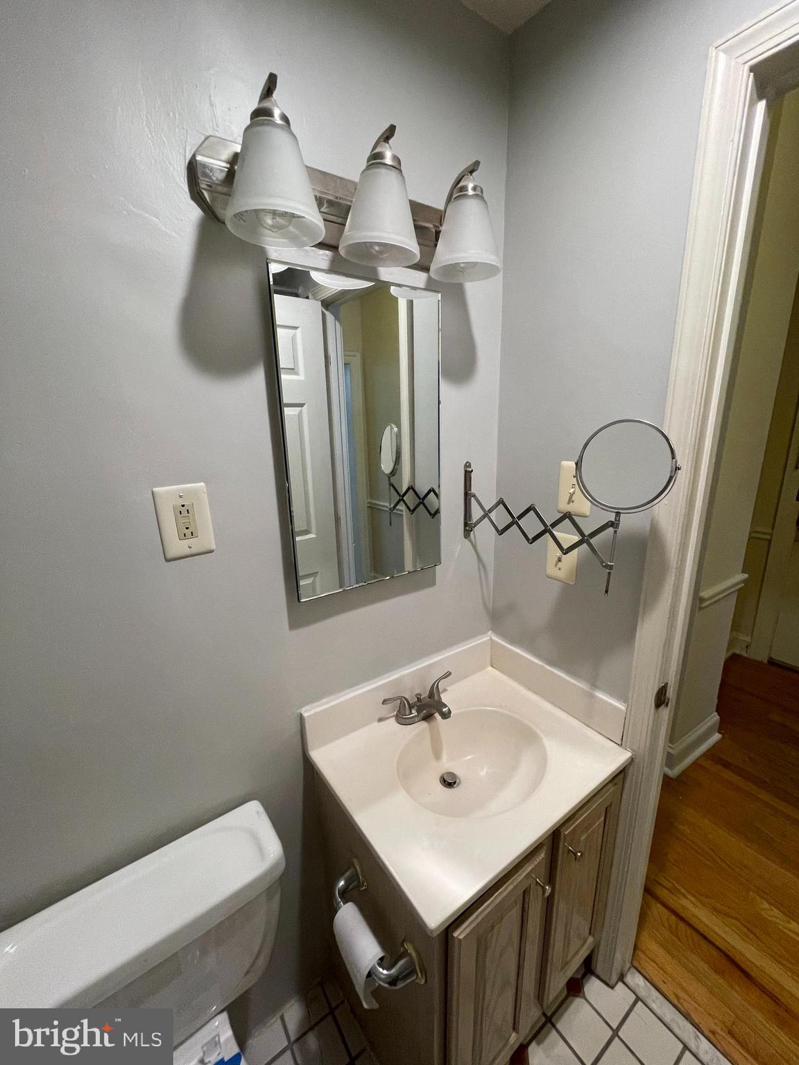 1820 Swann Street Northwest, Unit 101 Washington, DC 20009 - Photo 15 of 15 a bathroom with a sink a toilet and mirror