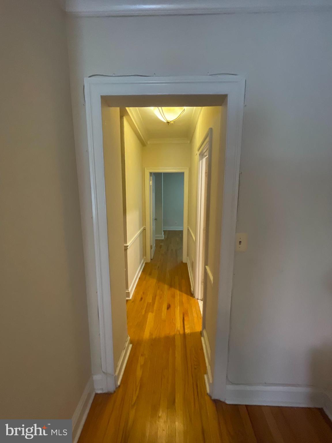 1820 Swann Street Northwest, Unit 101 Washington, DC 20009 - Photo 6 of 15 a view of a bedroom from a hallway
