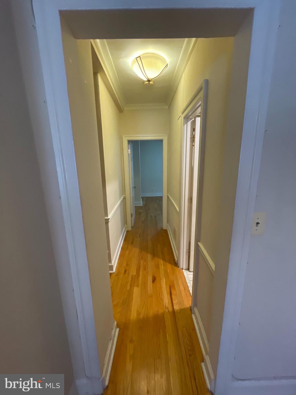 1820 Swann Street Northwest, Unit 101 Washington, DC 20009 - Photo 7 of 15 a view of a hallway with wooden floor