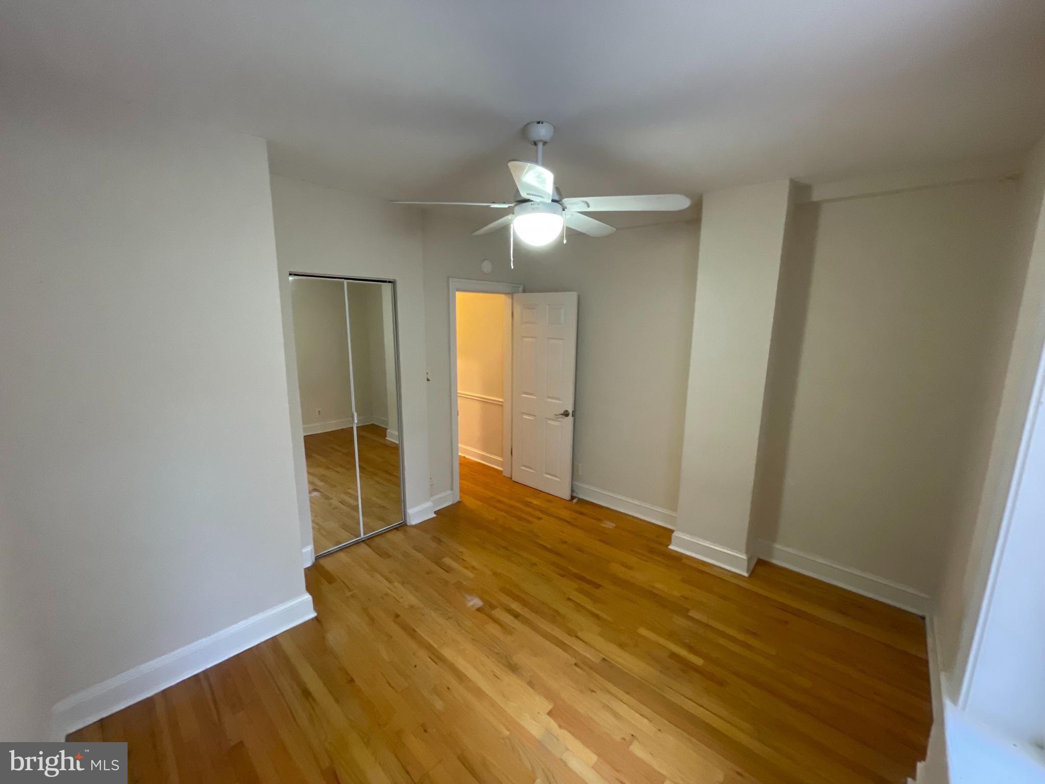 1820 Swann Street Northwest, Unit 101 Washington, DC 20009 - Photo 9 of 15 a bedroom with a bed and a chandelier