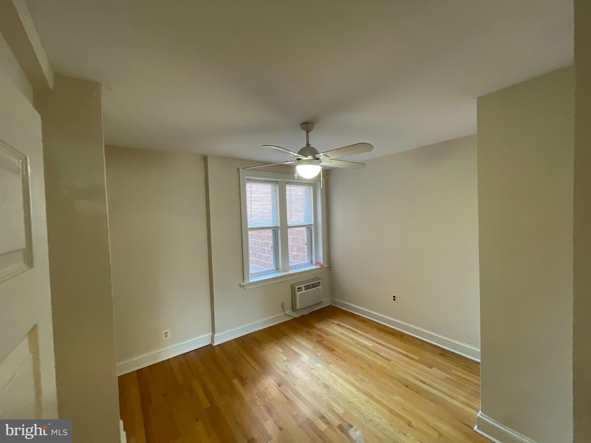 1820 Swann Street Northwest, Unit 101 Washington, DC 20009 - Photo 10 of 15 an empty room with wooden floor and windows