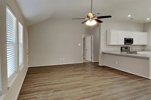 a view of kitchen with window and wooden floor