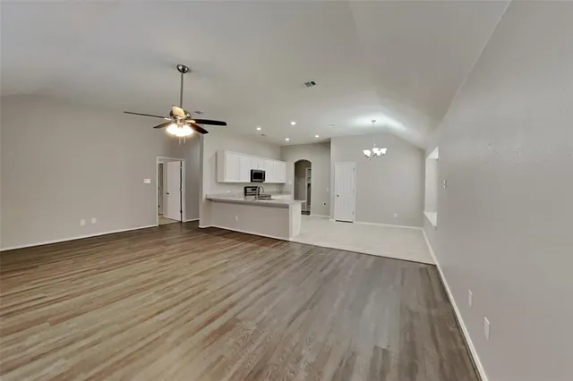 a view of a kitchen with a sink and wooden floor