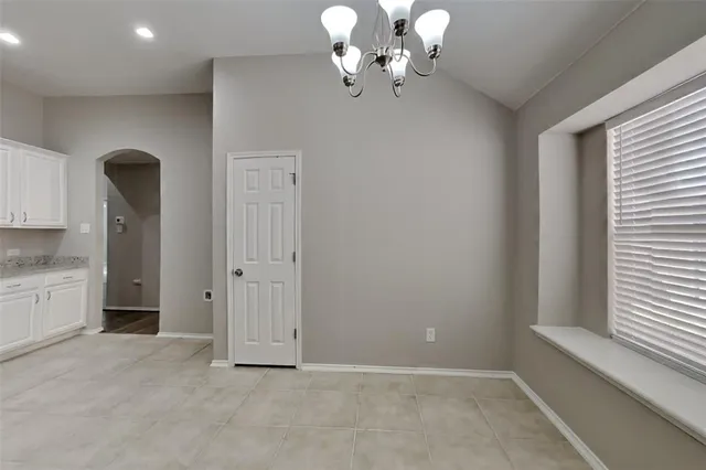 a large kitchen with stainless steel appliances granite countertop a sink and cabinets