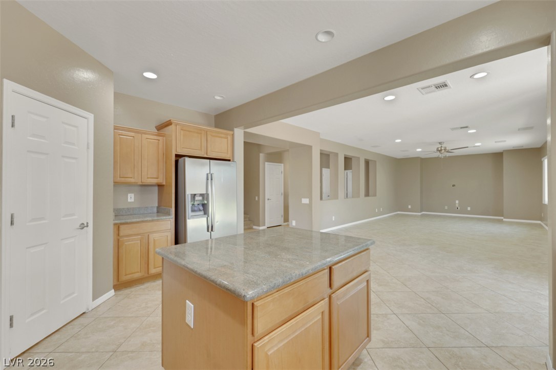 2501 Bechamel Place Henderson, NV 89044 - Photo 8 of 50 An open-concept living space with a kitchen island and tile flooring throughout.
