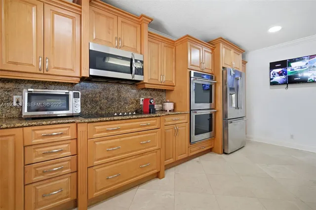 a kitchen with granite countertop cabinets stainless steel appliances and a sink